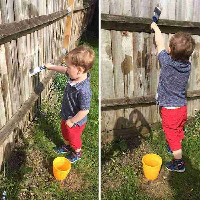 Keep Your Toddler Busy By Letting Them Paint The Fence With Water